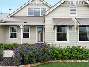 Cream Weatherboard with White Gable Fretwork and Window Trims with Lavender Garden Pebble Walkway